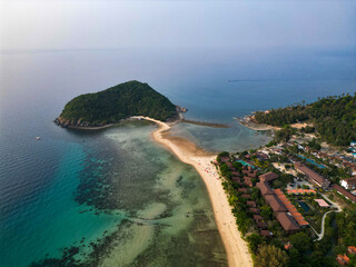 Aerial drone view small Koh Ma island, Ko Phangan Thailand. Exotic coast panoramic landscape, Mae Haad beach, summer day. Sandy path between corals. Vivid seascape, mountain coconut palms from above.