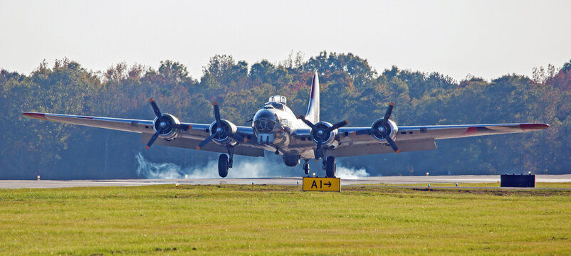 B-17 Bomber Landing on a Runway with Tire Smoke