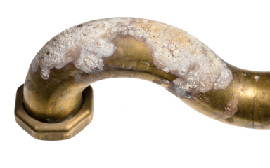 corrosion on brass elbow of bath tub close up isolated on white background