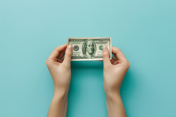 Woman hands with US dollars banknote on blue background