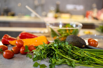 Fresh vegetables and herbs on the table in the kitchen. Selective focus.