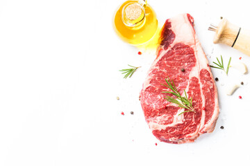 Beef steak ribeye with spices and herbs on black background.