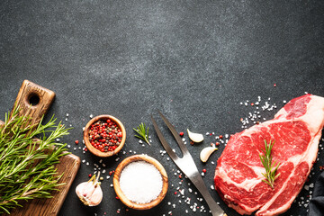 Beef steak, raw meat on black.
