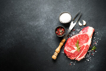 Beef steak, raw meat on black.