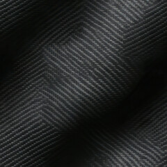 Close-up view of a black carbon fiber pattern, highlighting its detailed weave and texture