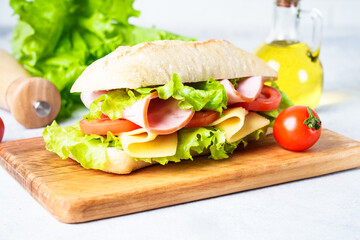 Ciabatta sandwich with lettuce, cheese, tomatoes and ham.