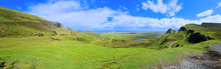 Fototapeta na wymiar Isle of Skye, Scotland. Panoramic view over the green mountain highland landscape of the Quiraing.