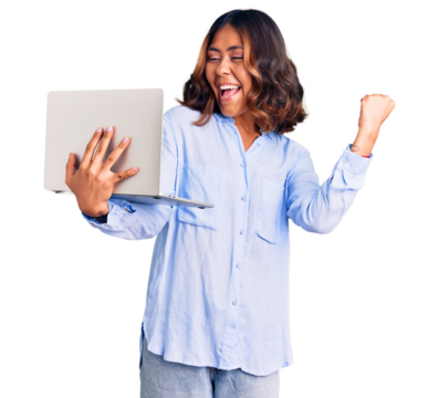 Young beautiful mixed race woman working using computer laptop screaming proud, celebrating victory and success very excited with raised arms - Powered by Adobe