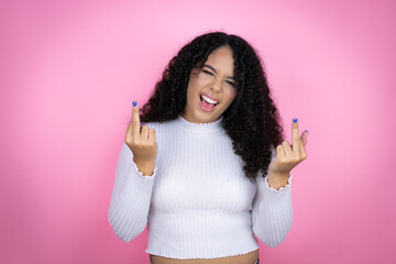 African american woman wearing casual sweater over pink background showing middle finger doing fuck...