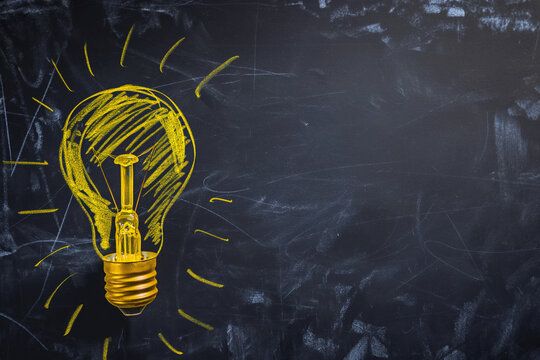 Close-up of yellow hand-drawn light bulb with the text idea, idea concept, light bulb in idea concept, idea light bulb in hand drawn with yellow chalk