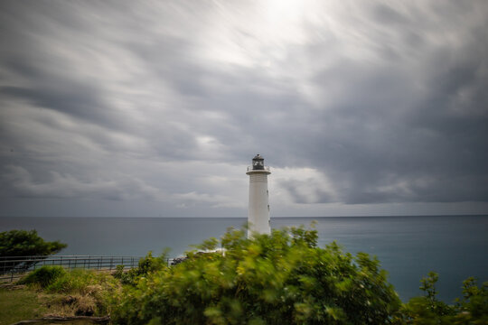 Le Phare du Vieux-Fort, white lighthouse on a cliff. Dramatic clouds overlooking the sea. Pure Caribbean on Guadeloupe, French Antilles, France