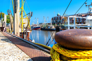 Traditional harbor scene with fishing boats in Neuharlingersiel , Nordsee, Germany
