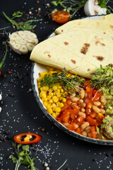 Mexican tacos on pita with vegetables salad, meat, pepper and corn on rustic wooden white table background. Recipe traditional food. Top flat view, overhead.