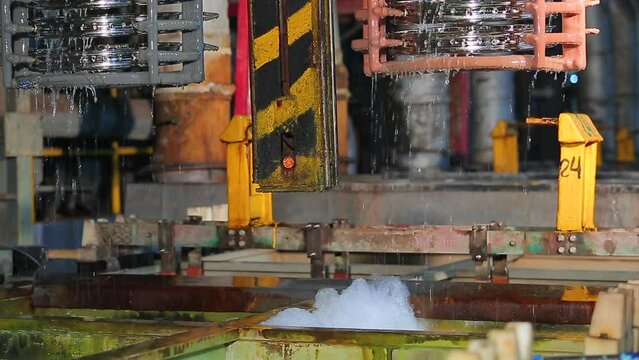 Oil quenching process. zinc plating process of metal tools in large containers of boiling chemicals working processes of the hot-dip galvanizing factory metal production. Galvanizing process.