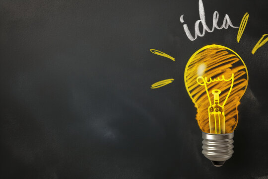 Close-up of yellow hand-drawn light bulb with the text idea, idea concept, light bulb in idea concept, idea light bulb in hand drawn with yellow chalk