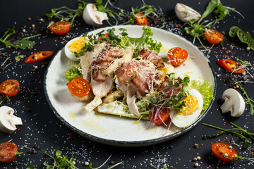 Fresh caesar salad in white plate on dark wooden table. Top view.