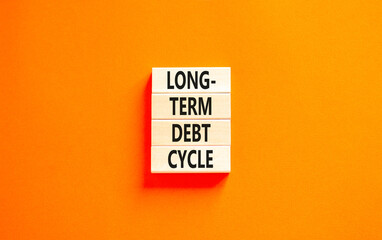 Long-term debt cycle symbol. Concept words Long-term debt cycle on beautiful wooden block. Beautiful orange table orange background. Business Long-term debt cycle concept. Copy space.