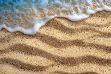 Fototapeta na wymiar Sea foam receding on the sandy beach, leaving behind a delicate, frothy texture.