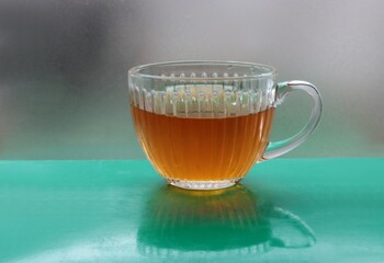 hot tea in transparent glass mug