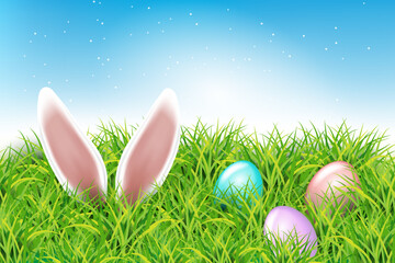 Colorful Easter eggs and rabbit ears sticking out of the grass. Spring landscape with blue sky. Spring easter design