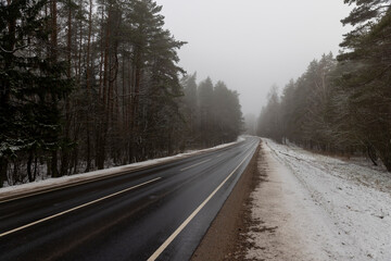 Fototapeta premium beautiful snow-covered road during fog in winter