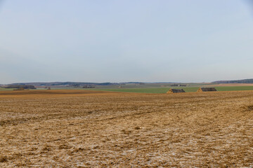 plowed frozen ground in the winter season with cracks