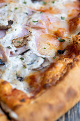 a slice of pizza with mushrooms and meat in sauce