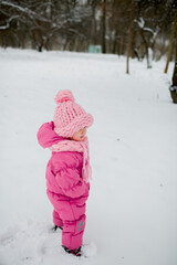 a little girl in a winter pink hat from merinos