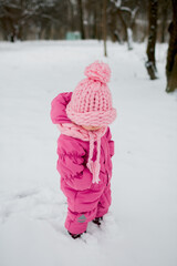 a little girl in a winter pink hat from merinos