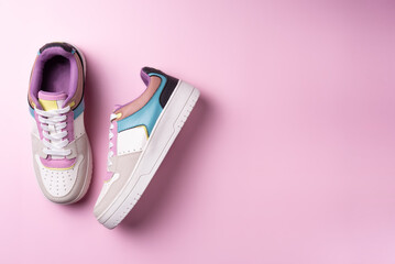 Colorful sneakers on pink background. Flat lay, top view