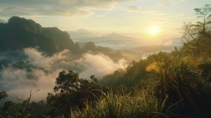 Naklejka premium Beautiful sunrise over the mountain with fog and grass