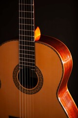 Classical Spanish flamenco guitar close up, dramatically lit isolated on black background with copy space.