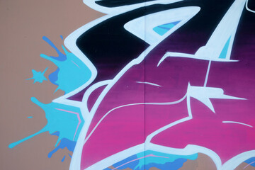 Colorful background of graffiti painting artwork with bright aerosol outlines on wall. Old school...