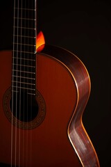 Classical Spanish flamenco guitar close up, dramatically lit isolated on black background with copy space.