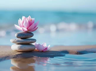 Foto auf Acrylglas Balanced stack of smooth stones with a pink lotus flower on sand © Nld