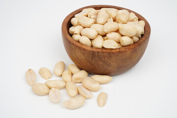 Wooden bowl full of roasted peeled peanuts Isolated Background