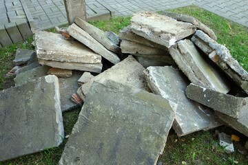 Dismantled old pavement made of square concrete slabs