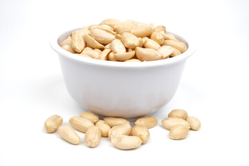 Many roasted peeled peanuts on a white cup Isolated Background