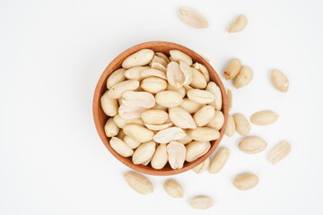A wooden bowl full of peeled peanuts Isolated Background