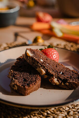 Delightful Vegan Breakfast: Vegetable Sticks, Fresh Fruits, and Homemade Banana Bread Adorned with Decorations, Basking in the Warm Glow of the Morning Sun