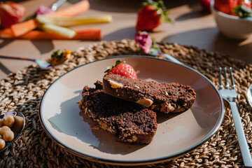 Delightful Vegan Breakfast: Vegetable Sticks, Fresh Fruits, and Homemade Banana Bread Adorned with Decorations, Basking in the Warm Glow of the Morning Sun