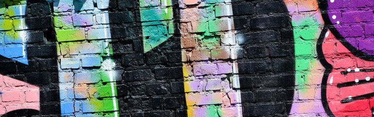 Colorful background of graffiti painting artwork with bright aerosol outlines on wall. Old school...