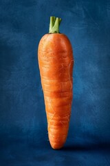 Vibrant orange carrot, dark blue background, generated with AI