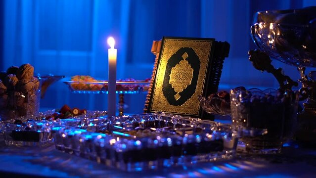 In the evening during Iftar in the month of Ramadan, the table is set. Book of the Koran on the table