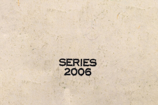 The inscription SERIES 2006 on a dollar bill. Fragment of a dollar bill. Money paper texture
