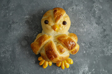 Overhead view of an easter chick made from hot cross buns