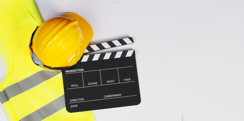 Clapper board and Safety Vest and SAFETY HELMET on black background.