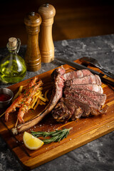 tomahawk steak and shrimps in sunset lighting