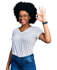 Young african american woman wearing casual white t shirt smiling positive doing ok sign with hand and fingers. successful expression.