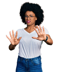 Young african american woman wearing casual white t shirt doing stop gesture with hands palms, angry and frustration expression